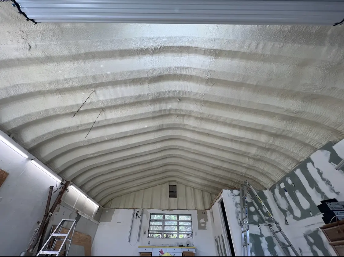 Spray polyurethane foam applied to the underside of a metal roof deck in Lander